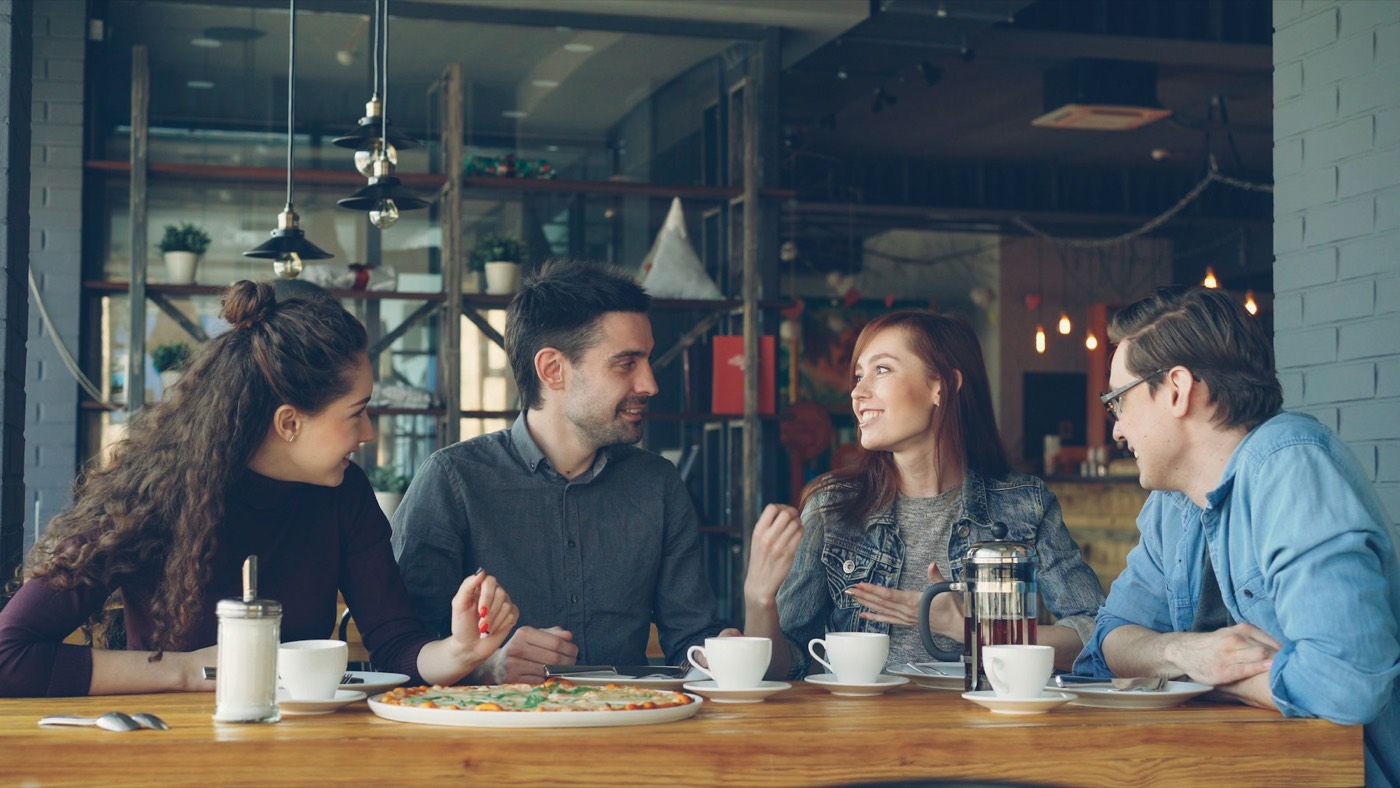 Friends talking together at a cafe